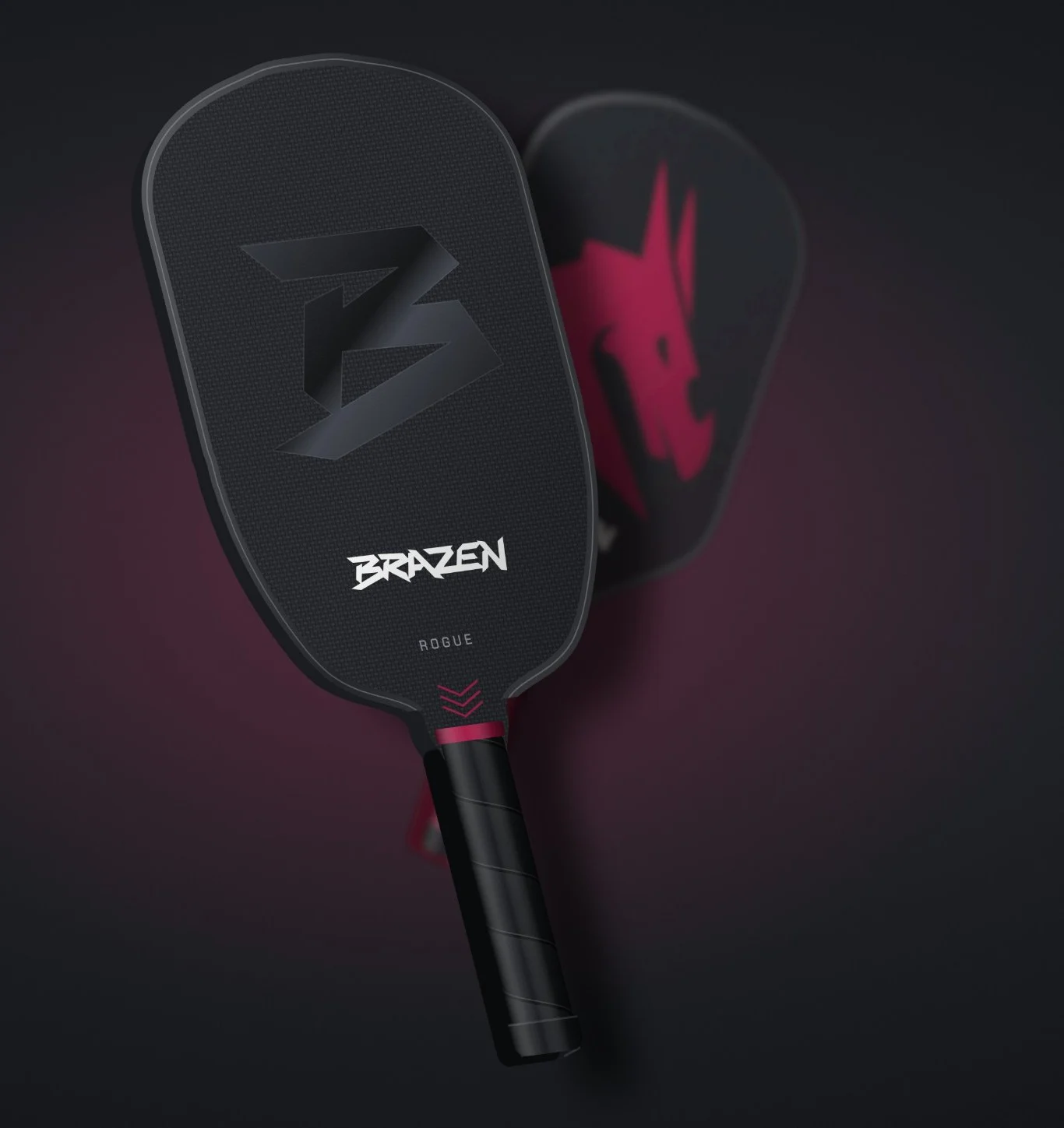 Brazen Rogue pickleball paddle at an angle with the Defiant paddle behind it